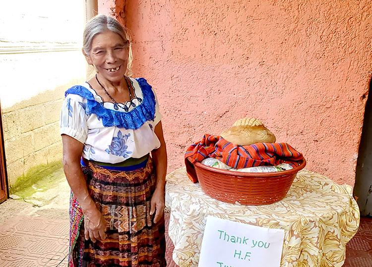 Image of Clara with food she received from Heaven's Family