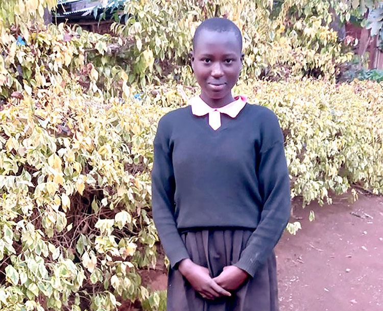 Image of student in Kenya in her school uniform