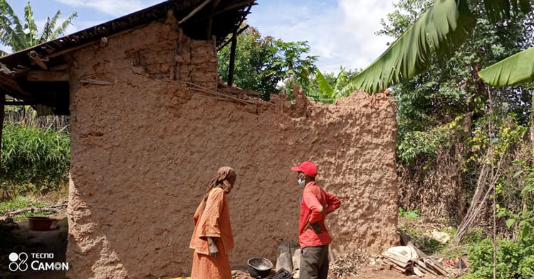 Picture of people from Rwanda assessing the damage house