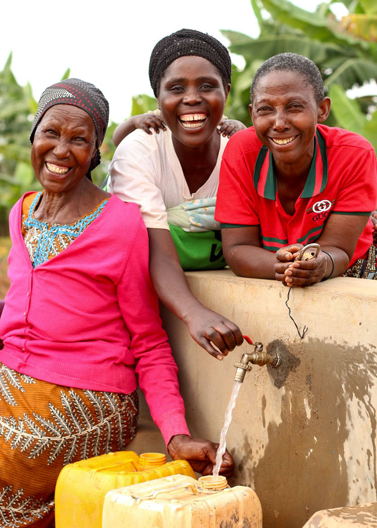 Image of ladies in Rwanda with clean water