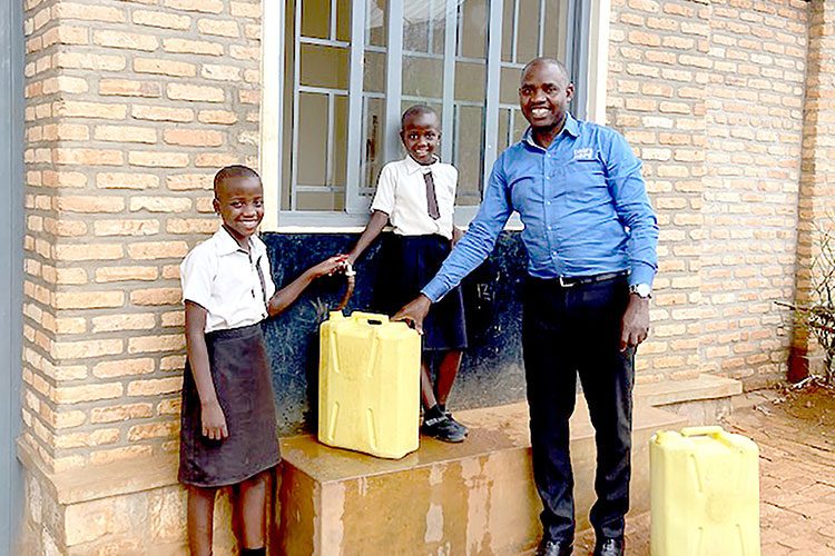 Image of dad in Rwanda with safe water