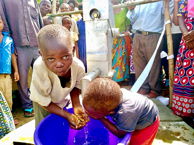 Image of villagers in Malawi enjoying new well